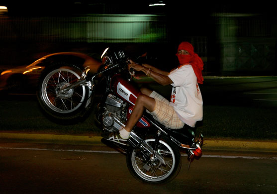 24 hours in pictures: A supporter of  Venezuela's President  Chavez after  a referendum victory