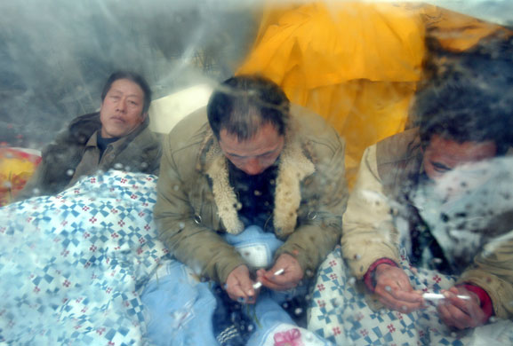 17 February 2009: Bucharest, Romania: Chinese construction workers take shelter