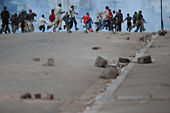 17 February 2009: Madagascar: Supporters of Mayor Andry Rajoelina run from tear-gas