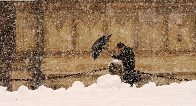 17 February 2009: Munich, Germany: A pedestrian crosses a snowy street