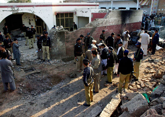 17 February 2009: Peshawar, Pakistan: Security officials inspect the site of a bomb blast