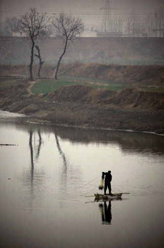 24 hours in pictures: A fisherman in Wulibao, China 