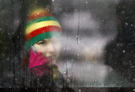 19 February 2009: Belgrade, Serbia: A woman talks on a phone as she rides in a bus