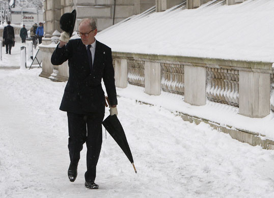 Gallery Snow in England: A pedestrian walks in the snow in Whitehall in central London