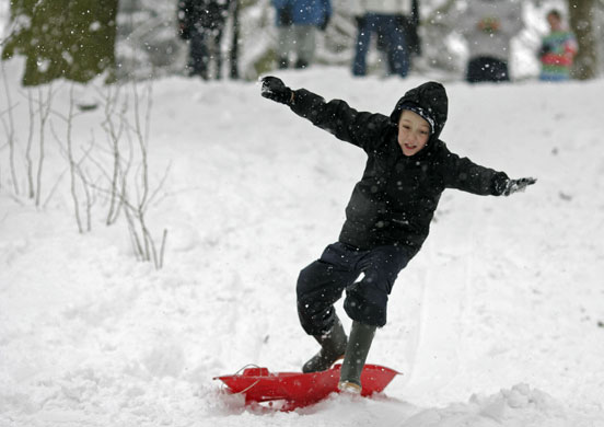 Gallery Snow in England: Croydon: Jimmy Marsh sledges in a park in south London.