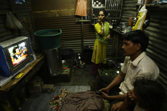 23 February 2009: Neighbours of Rubina Ali watch the Academy Awards in their home in Mumbai