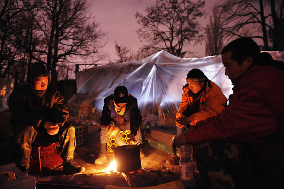 24 hours in pictures: stranded immigrants  outside Chine embassy in Romania