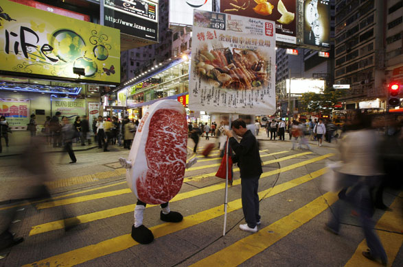 24 hours in pictures: A man dressed as a slab of beef advertising a restaurant in Hong Kong