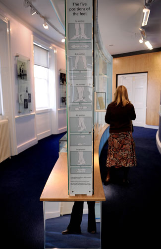 Ballet museum exhibits: Visitors are encouraged to try the five positions of the feet in ballet.