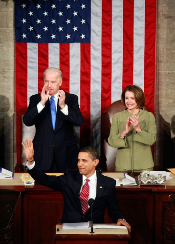 Barack Obama address: Barack Obama acknowledges applause as he arrives in the House chambers
