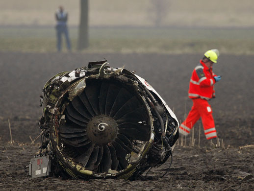 Turkish Airlines plane: An emergency worker walks past engine of a crashed Turkish Airlines plane.