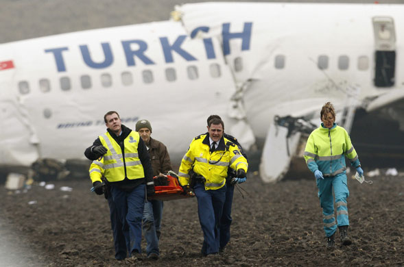Turkish Airlines plane: Emergency workers carry a wounded passenger from the Turkish Airlines plane