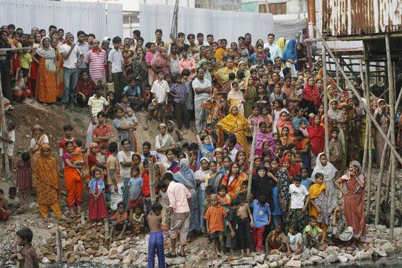 Bangladesh mutiny: People gather to look at the bodies of the Bangladesh Rifles in Dhaka.