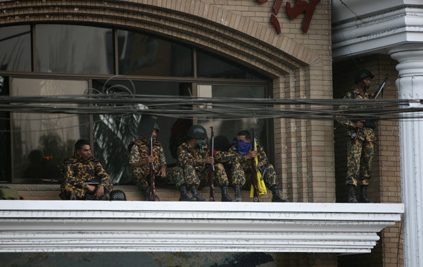 Bangladesh mutiny: Rebel soldiers guard the gate of the paramilitary Bangladesh Rifles HQ.