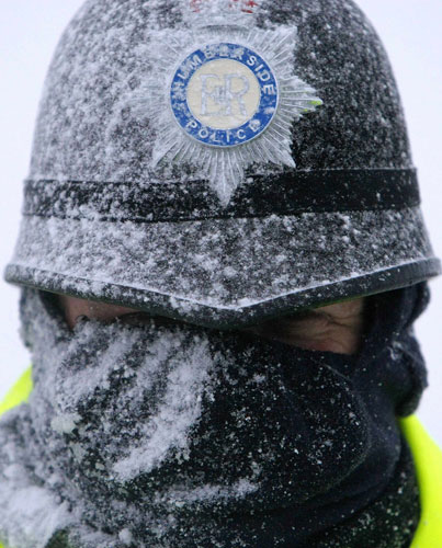 Gallery 3 February 2009: Lincolnshire, UK: A policeman stands outside the Total Lindsey refinery