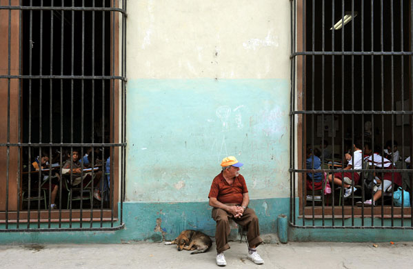 Gallery 3 February 2009: Havana, Cuba: A man rests outside a school