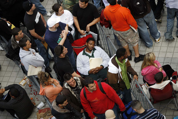 Gallery 3 February 2009: Miami: A man sleeps on a chair as he waits to file an application for a job