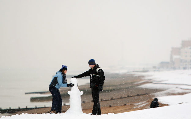 Gallery Snowman gallery: Brighton: A couple build a snowman on Brighton beach.
