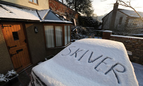 The word skiver drawn in snow on a car 