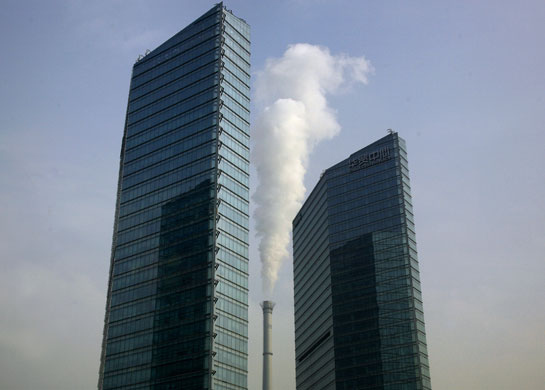 Gallery 24hours in pictures: A chimney stack between two newly counstructed buildings in Beijing
