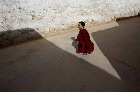 Gallery 24hours in pictures: Tibetan monk runs to a prayer meeting in a monastery near Tongren