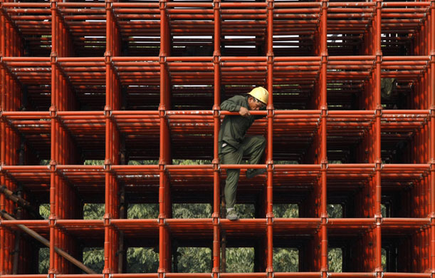 Gallery China property market: A labourer works on the scaffoldings