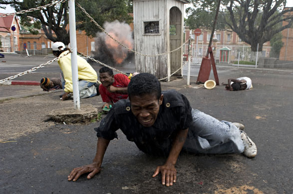 Gallery 8 February 2009: Antananarivo, Madagascar: A man tries to run from gun shots