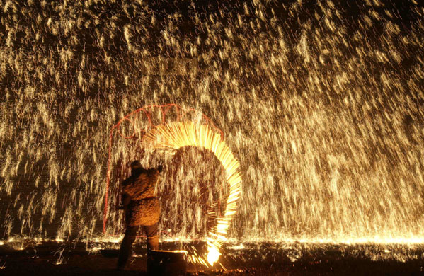 Gallery 9 February 2009: Nuanquan, China: A man celebrates the Lantern Festival