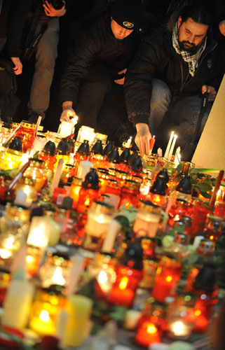Gallery 9 February 2009: Romania: Handball supporters place candles by a photograph Marian Cozma