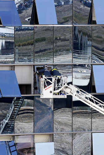 Gallery 9 February 2009: Spain: Firefighters check windows on a building after a car bomb exploded