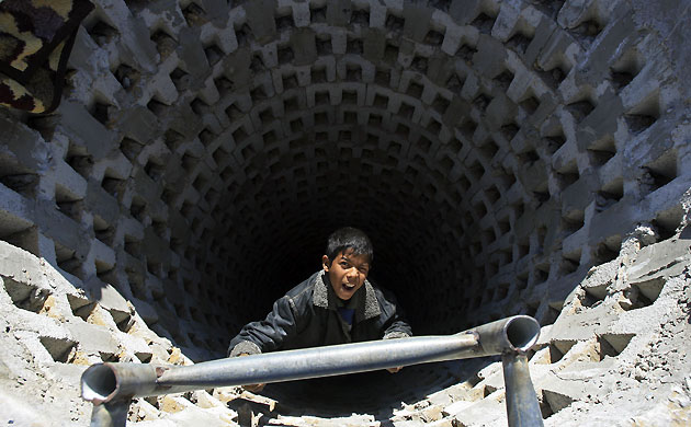 Gallery Tunnels under Gaza: Gaza tunnels a Palestinian boy looks up from a tunnel