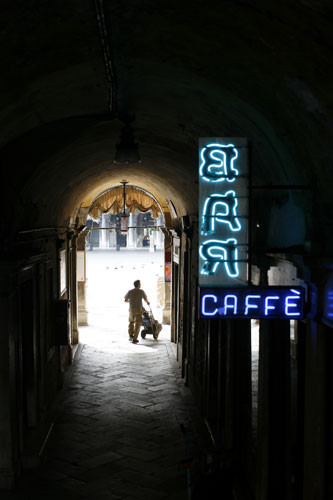 Venice in decline: A neon sign for a bar and cafe in an alley, Venice, Italy. 