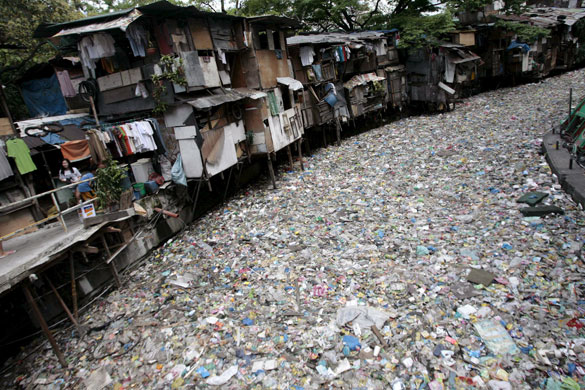 Manila, Philippines: A polluted creek covered with rubbish.