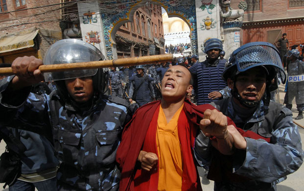 Kathmandu Uprising day: Nepalese riot police detain a Tibetan Buddhist monk in Kathmandu.