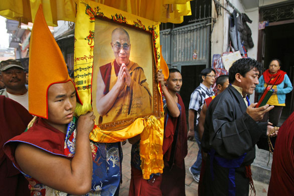Kathmandu Uprising day: Tibetan monks carry the photograph of their spiritual leader Dalai Lama.