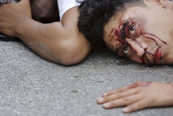 10 March 2009: Guatemala City: A man lies on the ground after being detained by the police
