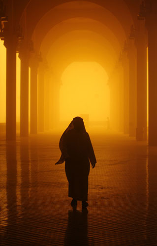 10 March 2009: Riyadh, Saudi Arabia: A man walks through a sand and dust storm