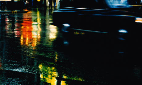 A london taxi or black cab at night