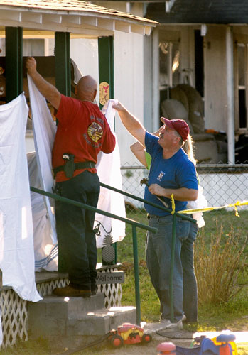 Alabama shooting: Law enforcement personnel use sheets at the scene of a shooting in Samson.