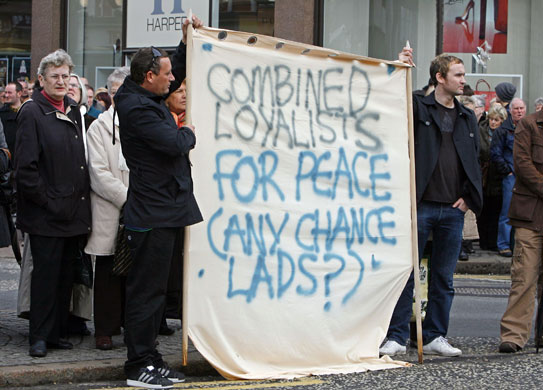 Belfast peace rally: Two men hold a banner during the peace vigil
