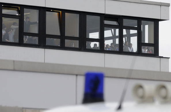 Germany school shooting: Pupils look from windows at the Albertville school complex in Winnenden.
