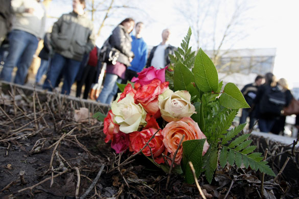 Germany school shooting: People stand near flowers in front of the Albertville School Centre 