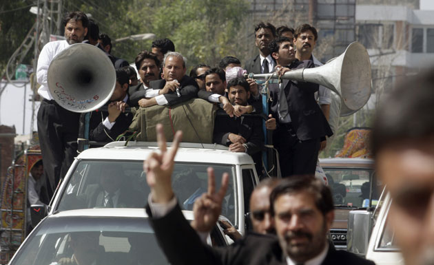 Pakistan lawyers protest: Pakistani lawyers march in a road during a demonstration.
