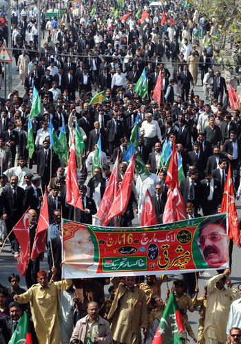 Pakistan lawyers protest: Pakistani lawyers and political party activists march in a protest rally.