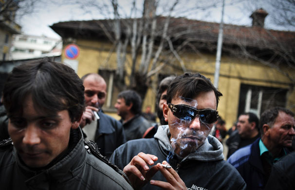12 March 2009: Sofia, Bulgaria: A blind farmer smokes during a rally