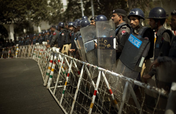 12 March 2009: Lahore, Pakistan: Police officers block the street during a demonstration