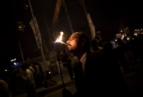 24 hours in pictures: Lahore, Pakistan: A Pakistani lawyer lights a cigarette during protests