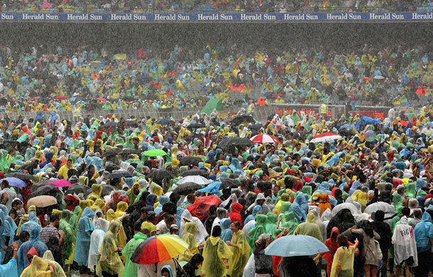 24 hours in pictures: Melbourne, Australia: The crowd stand in the rain Sound Relief concert. 