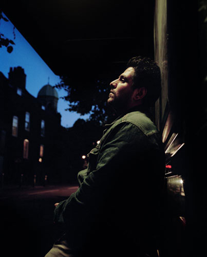 Asylum seekers: Asylum seeker Hamid, 28 from Iran sits at a bus stop in London. 