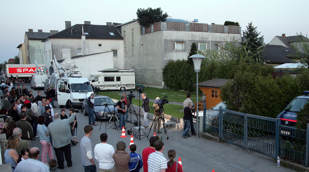 Abuse in Amstetten: Townspeople and the media gather behind Josef Fritzl's house in April 2008